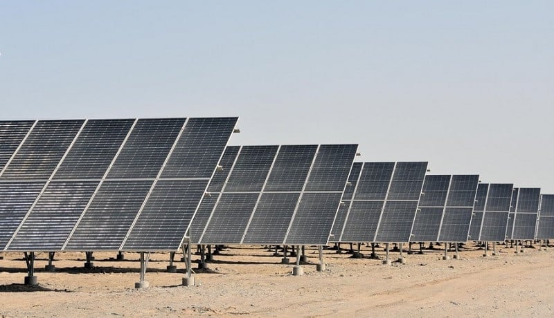 A row of solar panels in a desert